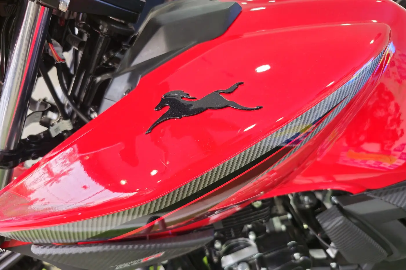 Close-up of a glossy red motorcycle fuel tank in clean condition